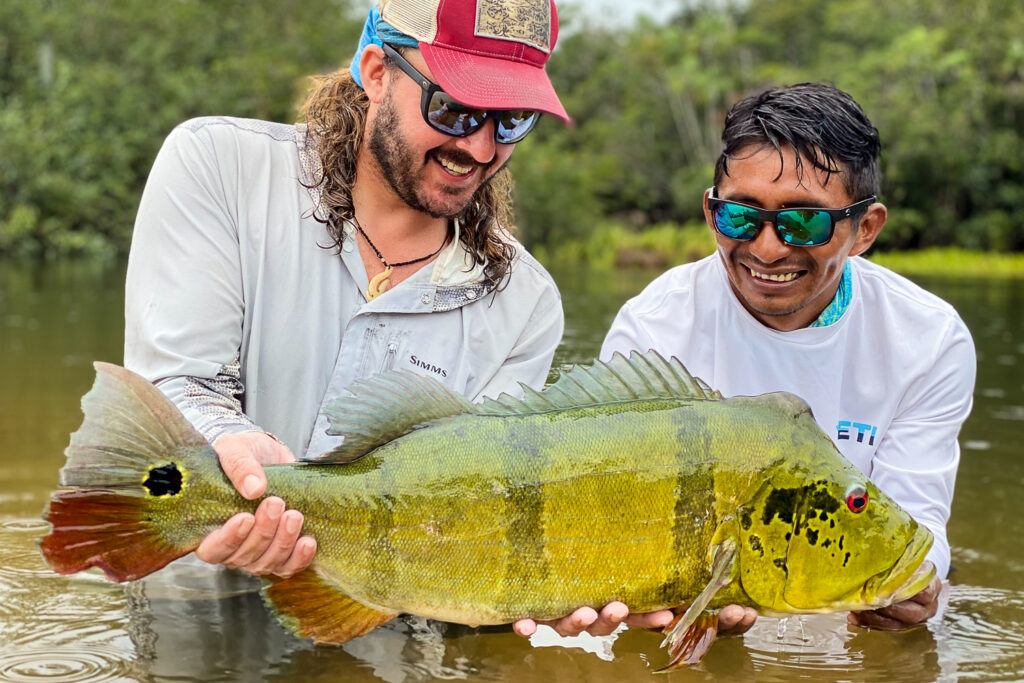Fly fisherman and guide with record peacock bass in Colombia. 
