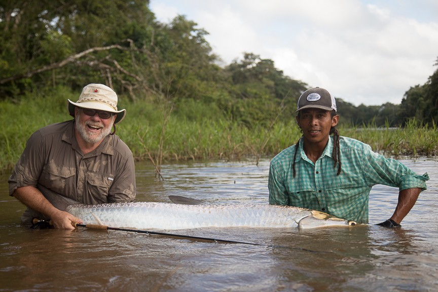 Guide and angler with large tarpon in water. 